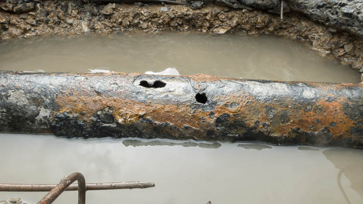Corroded pipe leaking under a slab in a Miami home